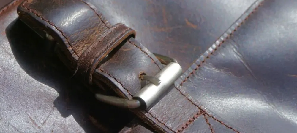 Close-up of a leather bag with a metal buckle closure