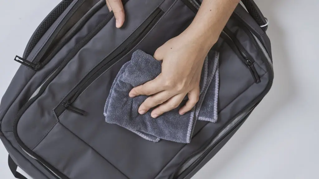 wiping down backpack