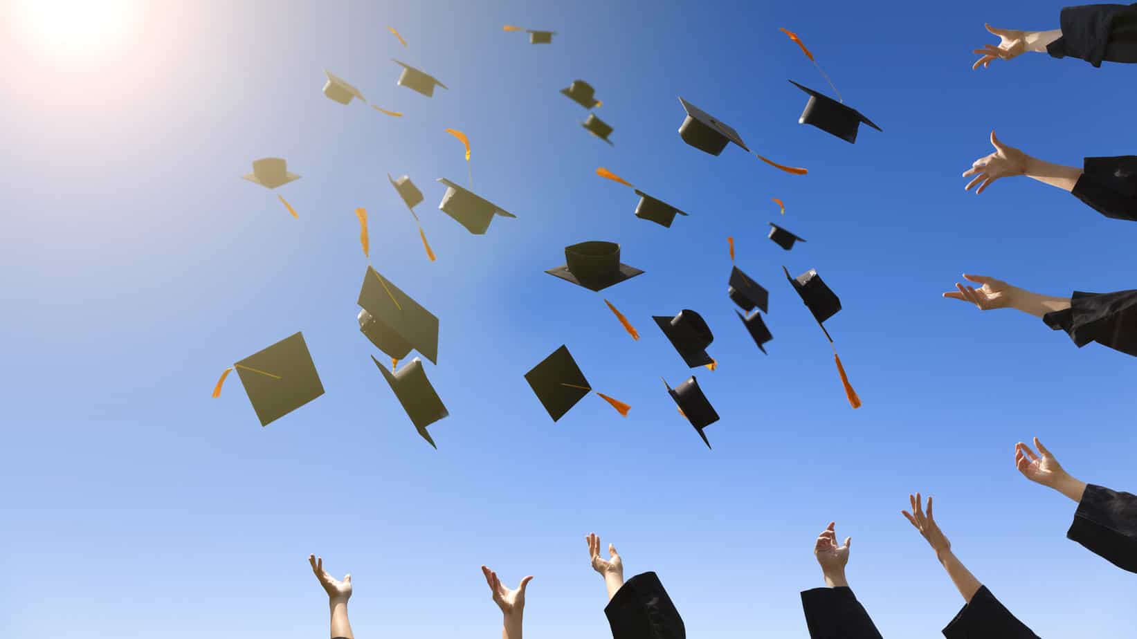 Article: The Best Backpack for Grad School Image: Grads throwing hats in the air