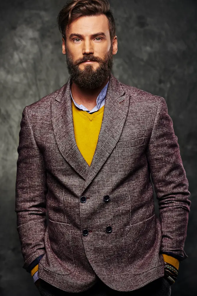 man with pop of color from yellow sweater